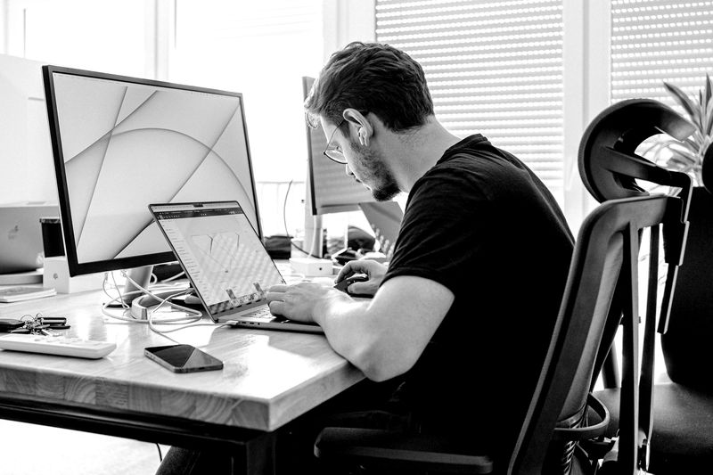 Developer working at a computer with several screens