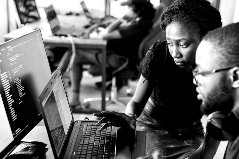 Colleagues looking at code on a screen